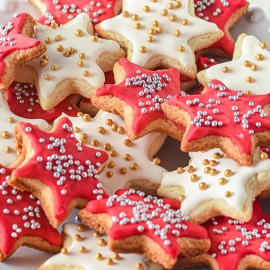 plate of christmas star cookies with silver and gold sprinkles