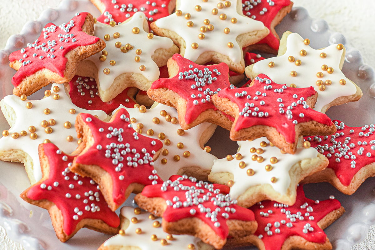 plate of christmas star cookies with silver and gold sprinkles