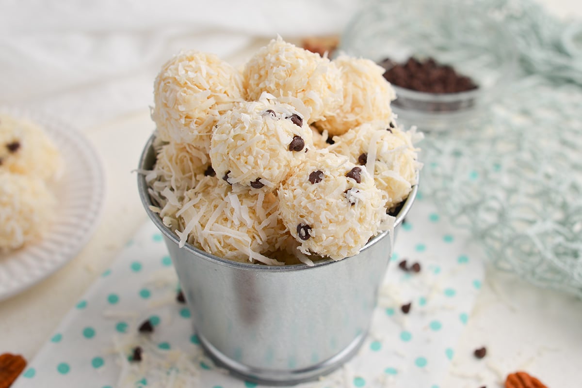 small metal bucket of coconut balls with and without chocolate chips