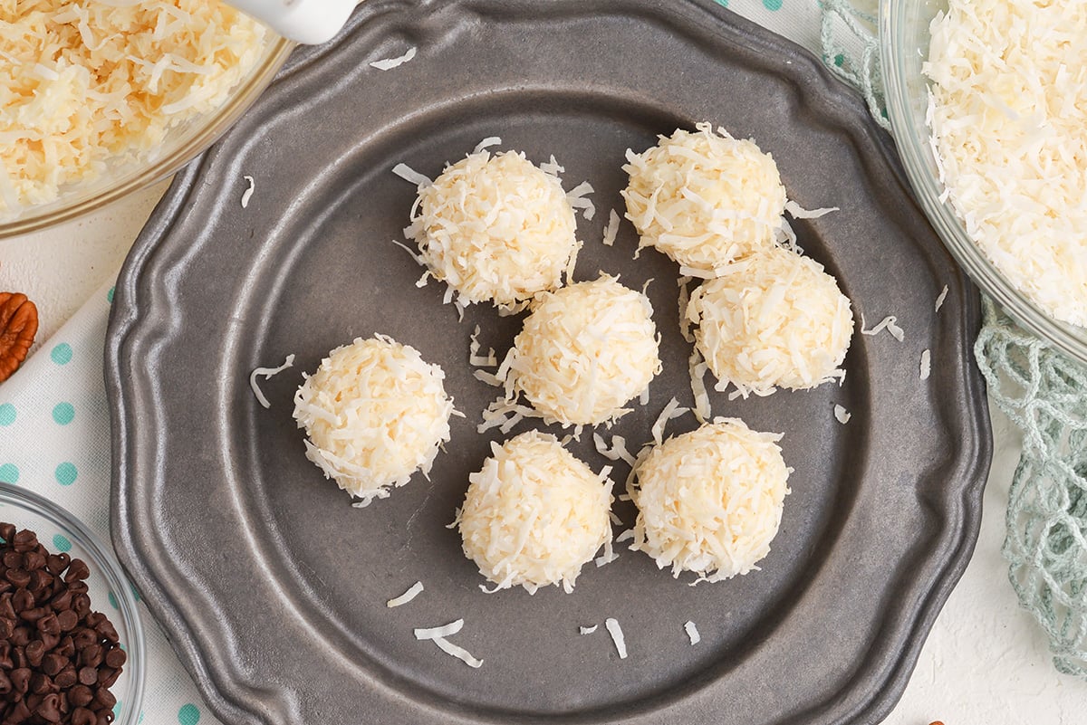 close up of no-bake coconut balls with pecans