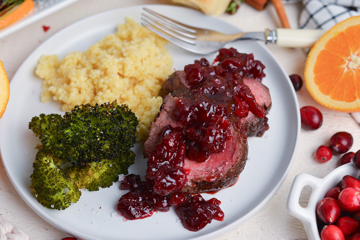 two slices of beef tenderloin with pastina and broccoli