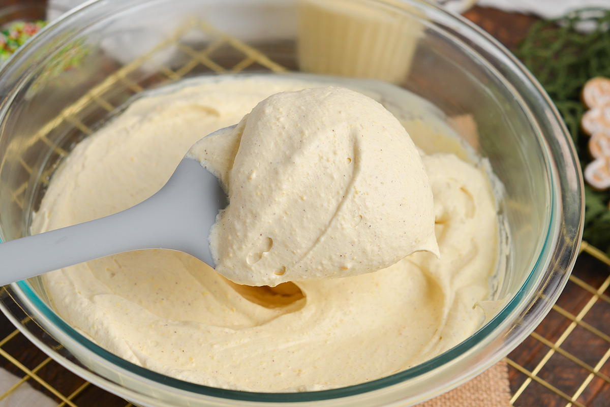 close up of eggnog dip on spatula