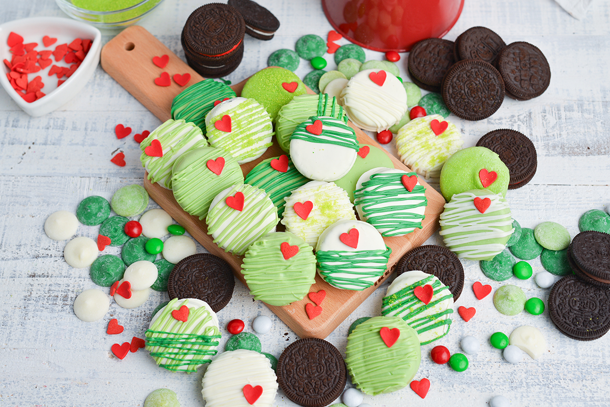overhead shot of grinch cookies on wooden tray