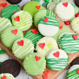 close up overhead shot of grinch cookies on wooden tray