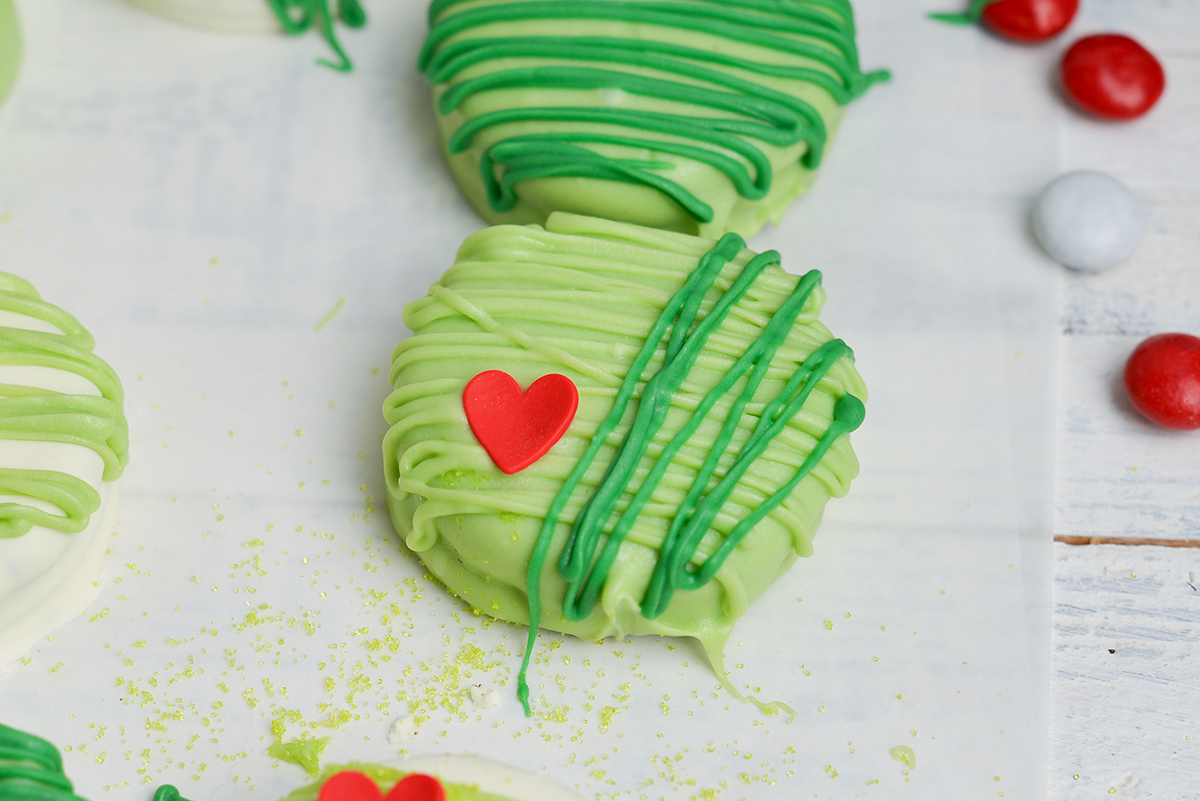 close up angled shot of green grinch cookie on parchment paper