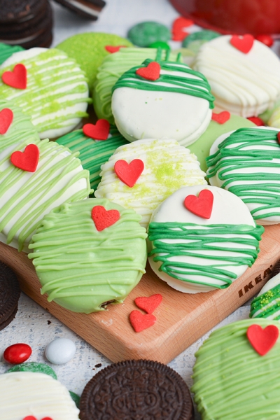 angled shot of grinch oreos on wooden board