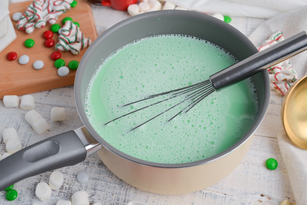 angle saucepan of green hot chocolate with a whisk 