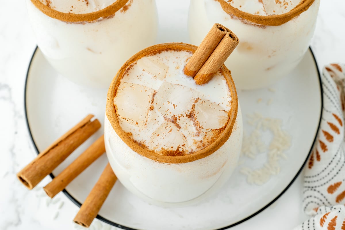 overhead angled shot of glasses of horchata on tray