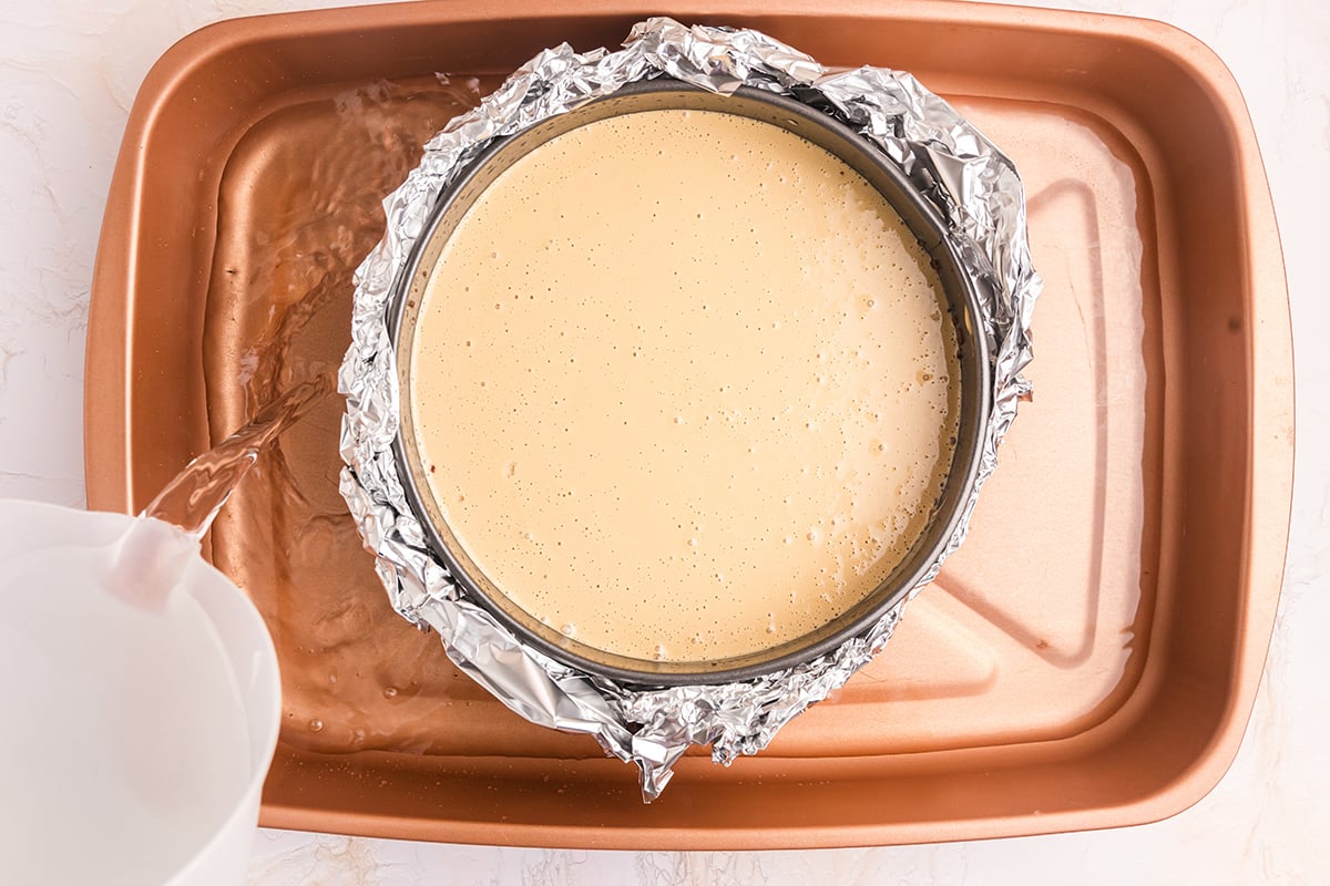 cheesecake batter in springform pan in water bath