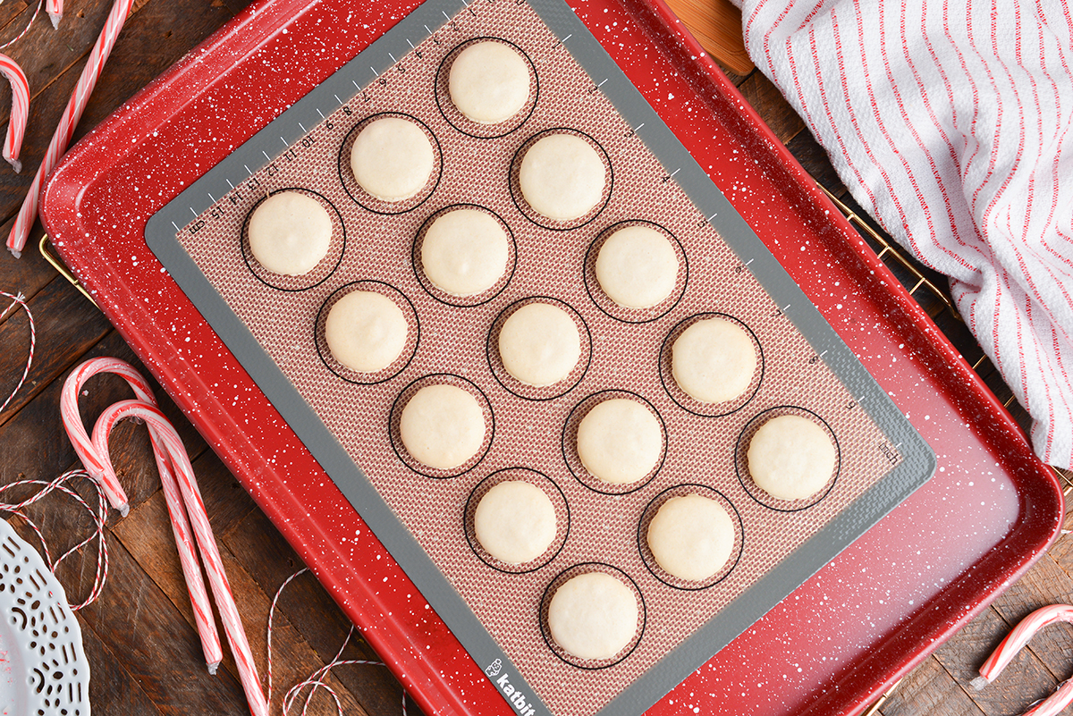 baked macaron shells on a baking sheet