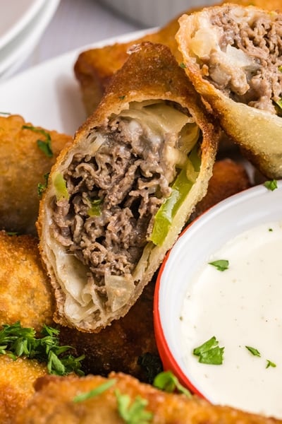 close up of philly cheesesteak egg roll cut in half