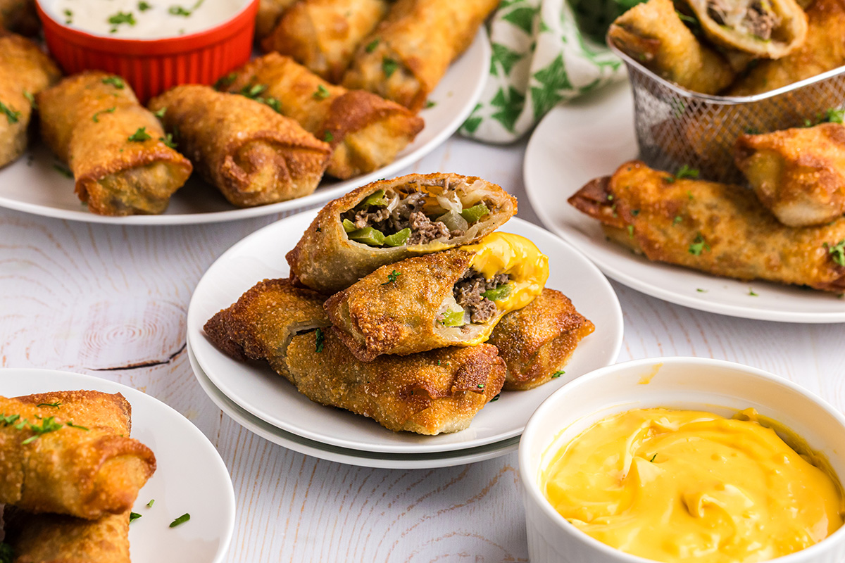 angled shot of plate of philly cheesesteak egg rolls