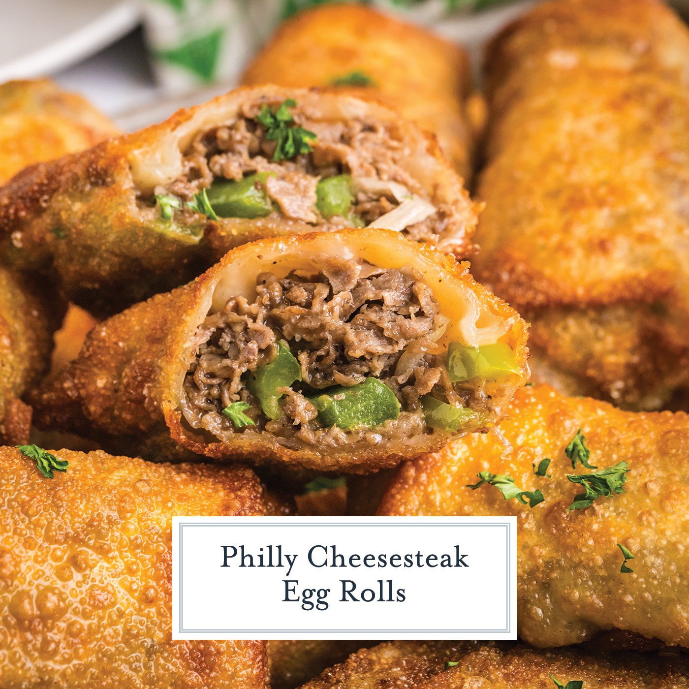 close up of philly cheesesteak egg roll cut in half with text overlay for facebook