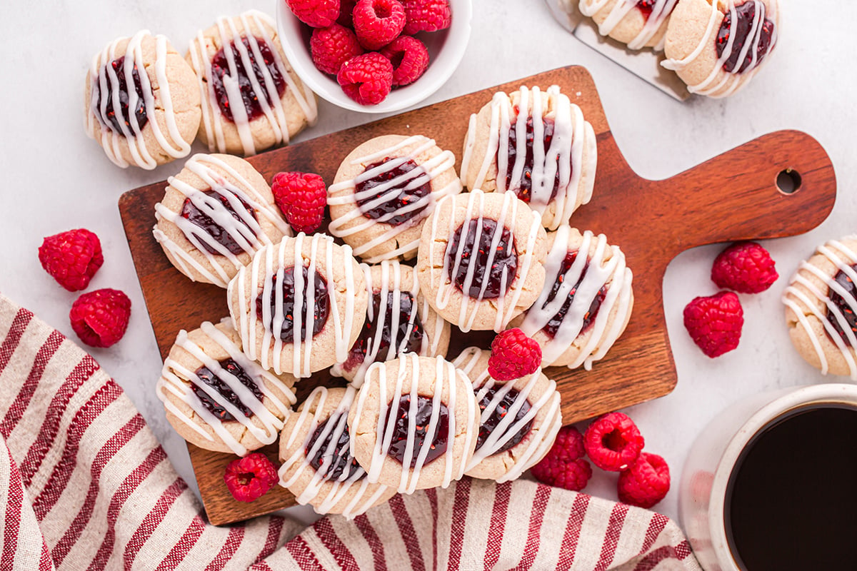 overhead shot of raspberry thumbprint cookies on board