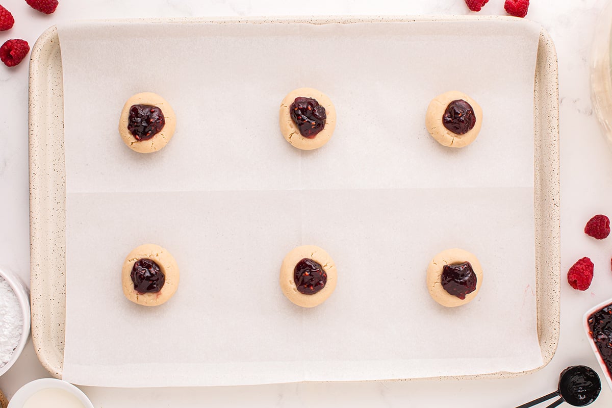 overhead shot of jam added to cookies