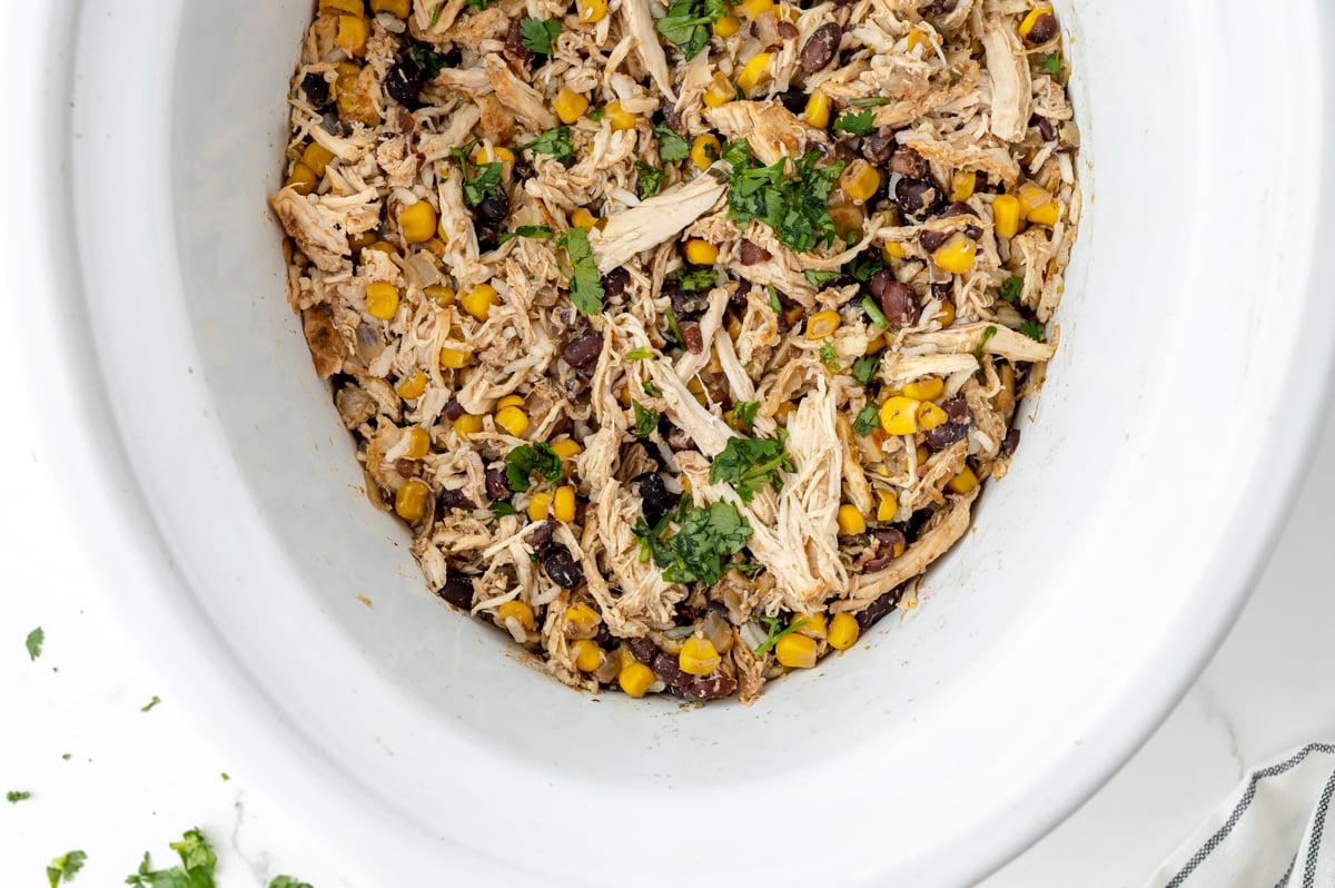 overhead shot of crock pot full of shredded chicken