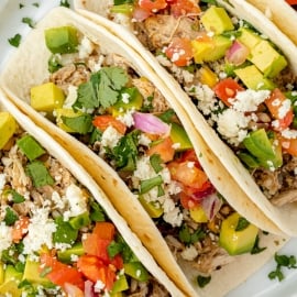 close up overhead shot of three slow cooker chicken tacos