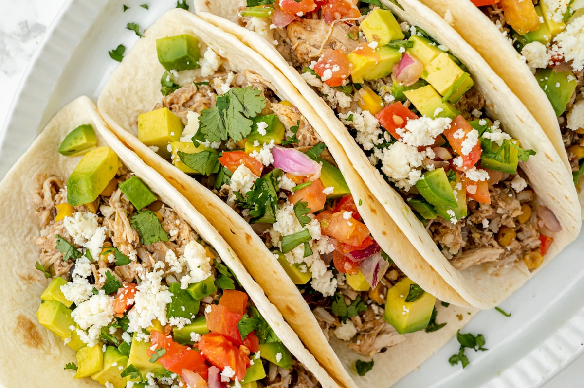 close up overhead shot of three slow cooker chicken tacos
