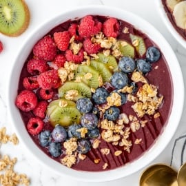 overhead shot of acai bowl topped with fruit and granola