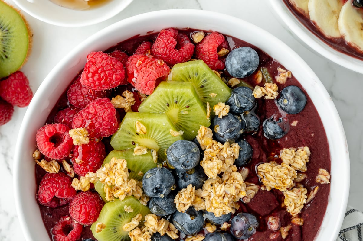 overhead half shot of smoothie bowl with toppings