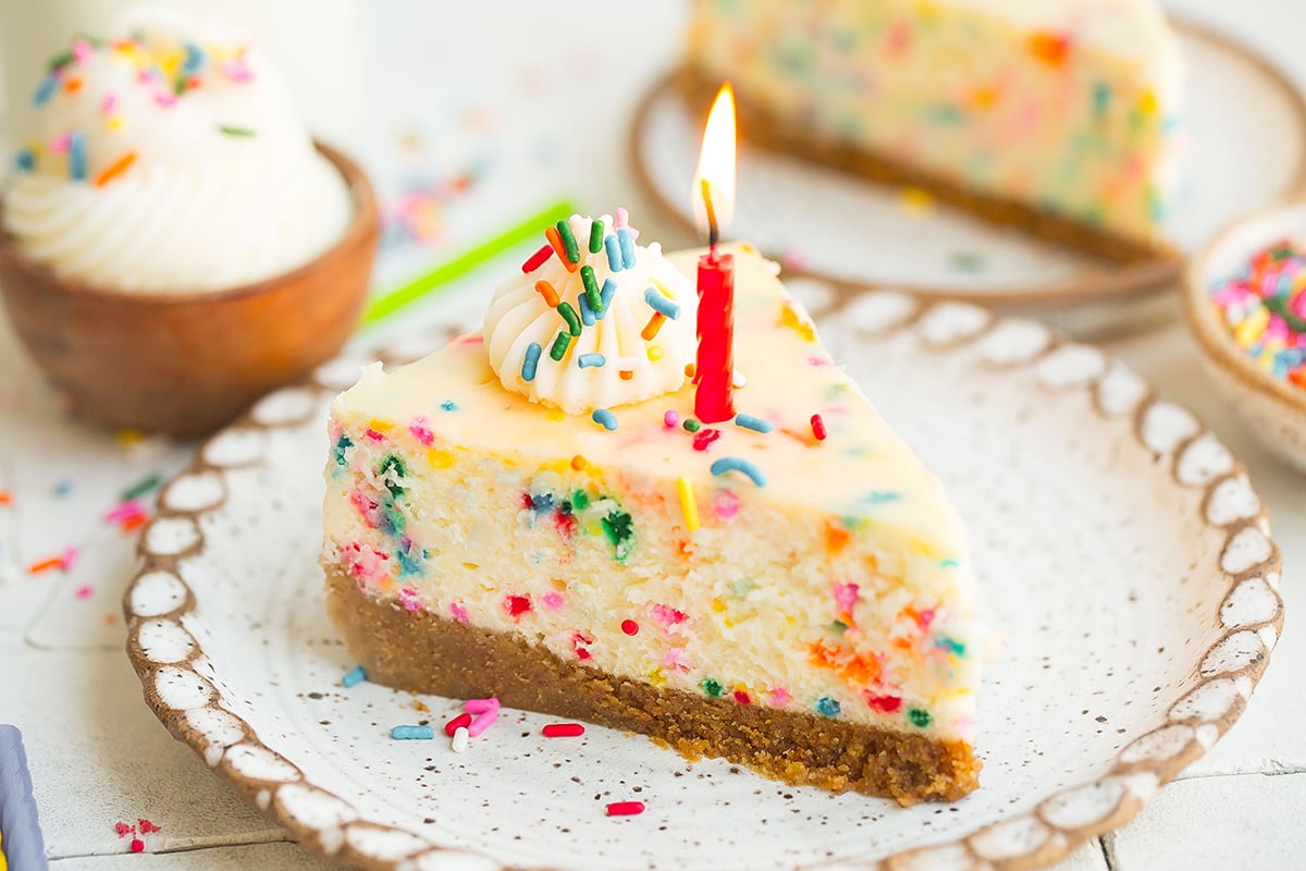 rainbow cheesecake with a birthday candle