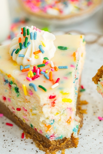 close up slice of cheesecake with graham cracker crust