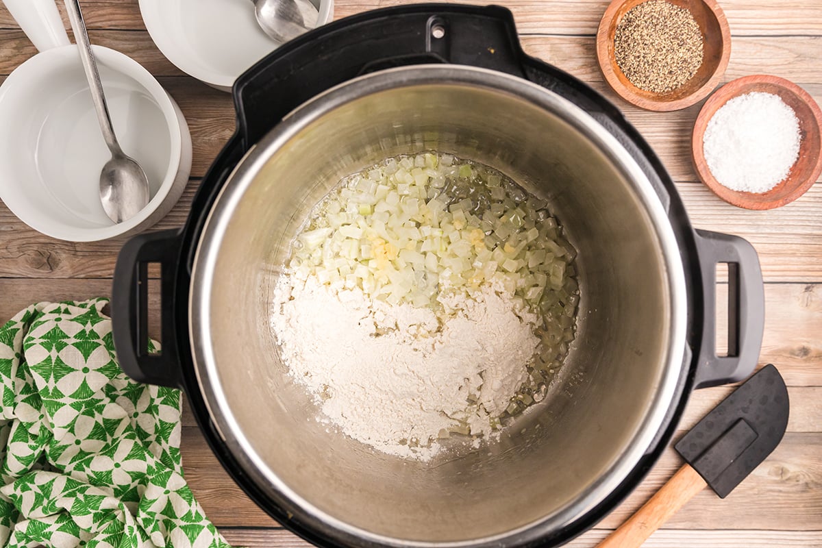 onions, garlic and flour in an instant pot bowl