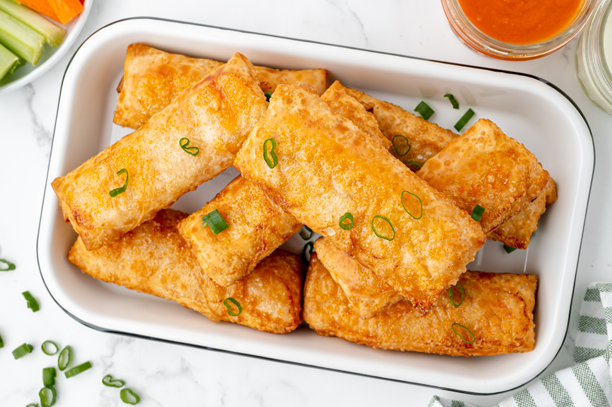 angled overhead shot of egg rolls in platter