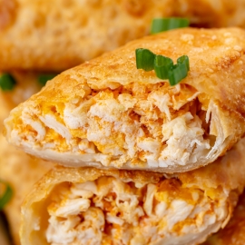 close up shot of buffalo chicken egg roll cut in half