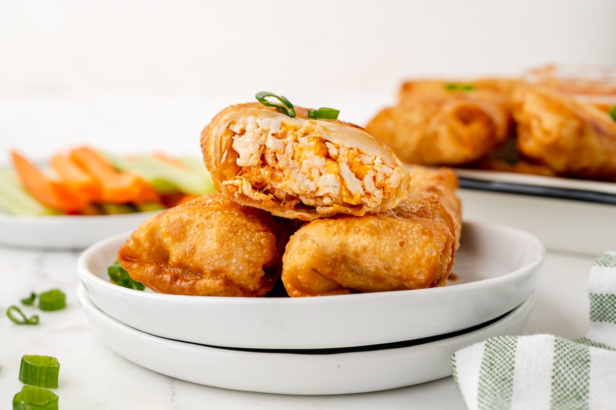 straight on shot of three buffalo chicken egg rolls on plate