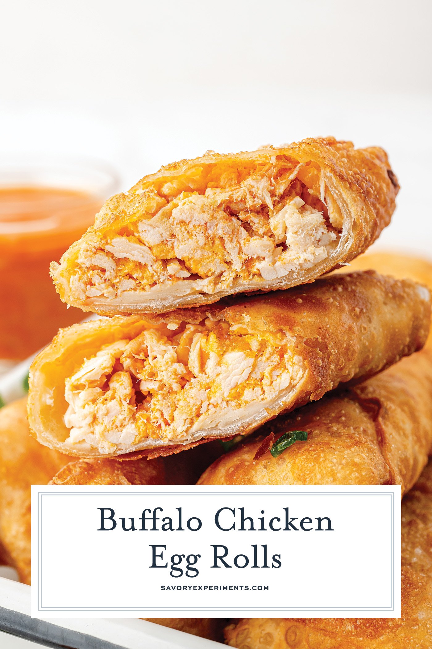straight on shot of buffalo chicken egg roll bit in half with text overlay for pinterest
