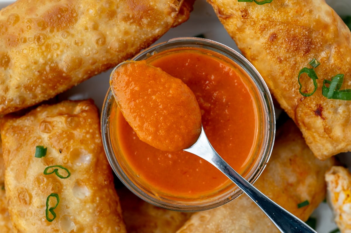 overhead shot of spoon in jar of buffalo sauce