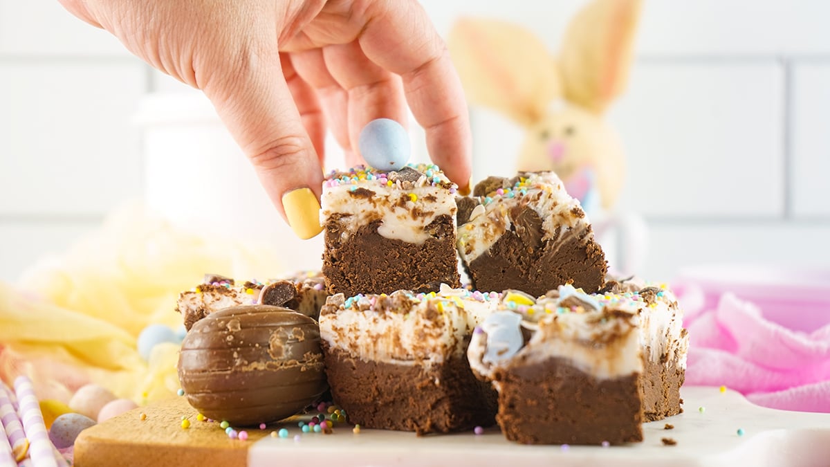 fingers grabbing piece of cadbury egg fudge