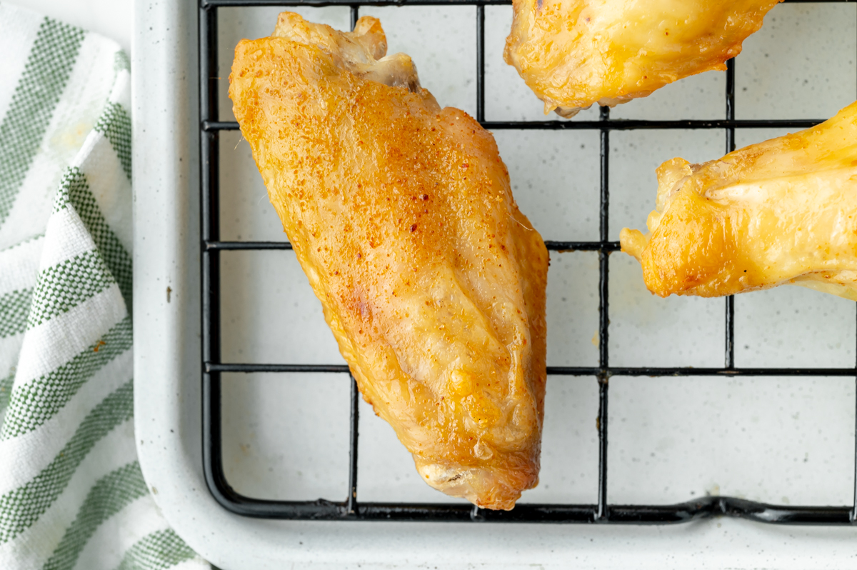 overhead close up shot of baked buffalo wing on wire rack