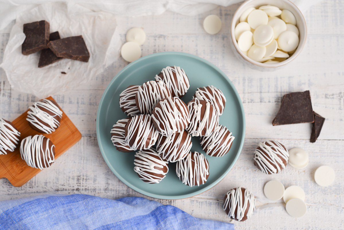 overhead shot of stack of chocolate cheesecake bites on blue plate