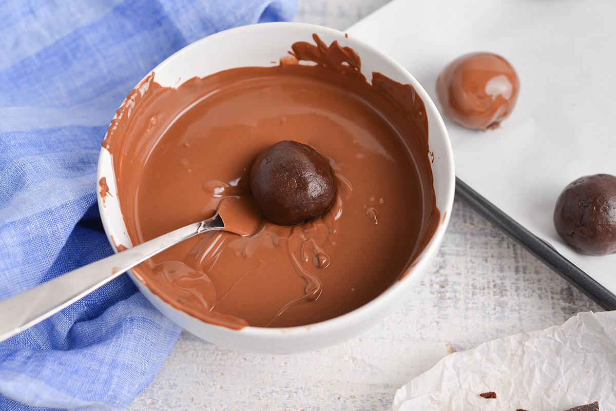 cheesecake ball dipped into melted chocolate