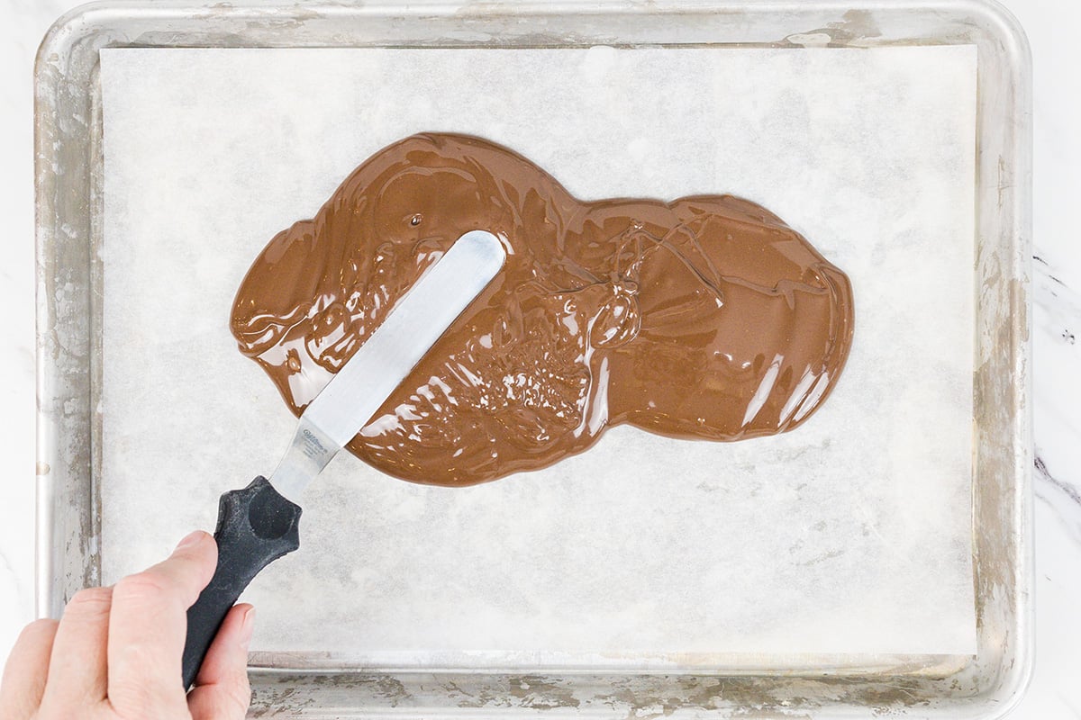 melted chocolate spread onto sheet pan with spatula