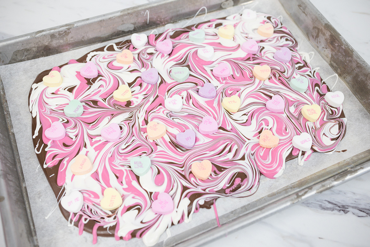 angled shot of conversation heart chocolate on sheet pan