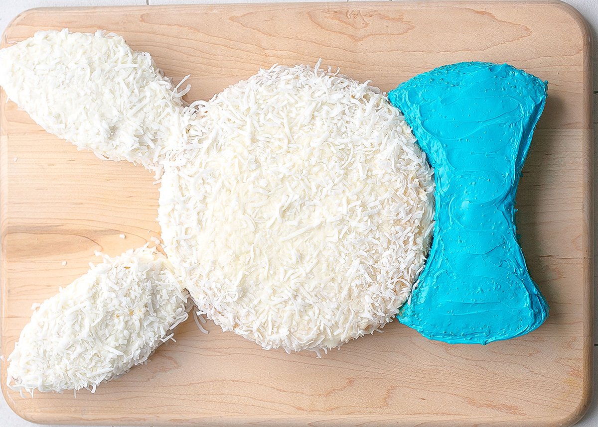 overhead shot of coconut bunny cake with blue bow tie