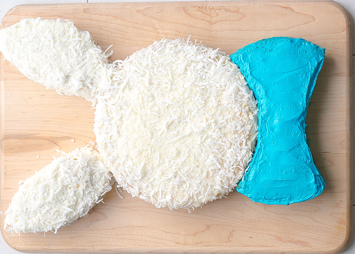 overhead shot of coconut bunny cake with blue bow tie