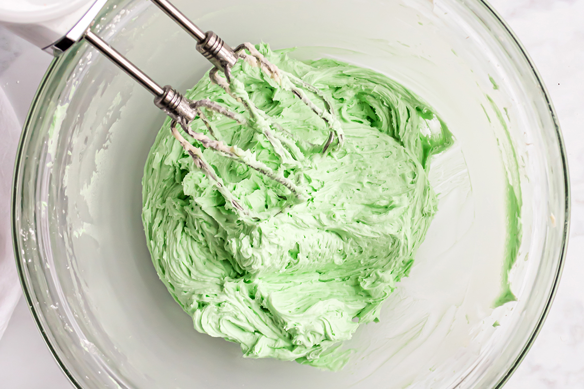 green frosting mixed in a glass bowl