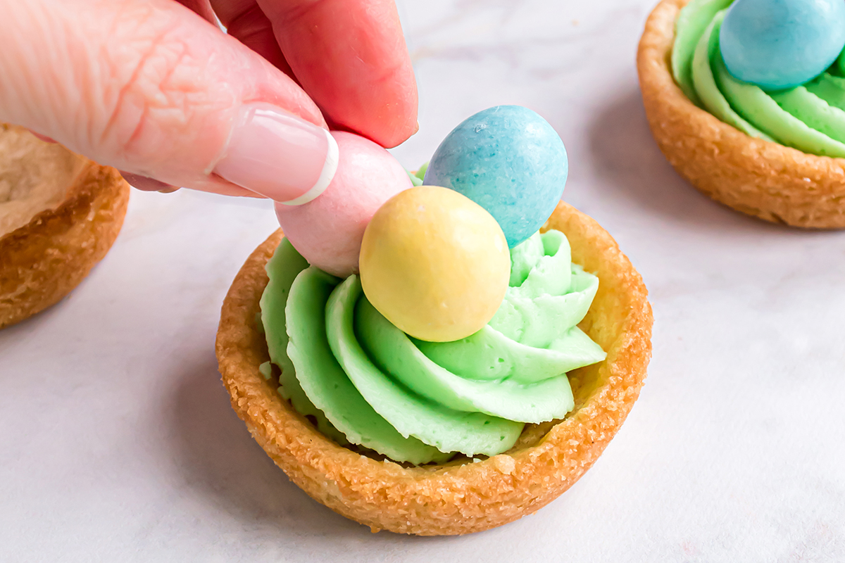 chocolate eggs placed on top of sugar cookie cups