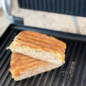 angled shot of tuna panini on panini press