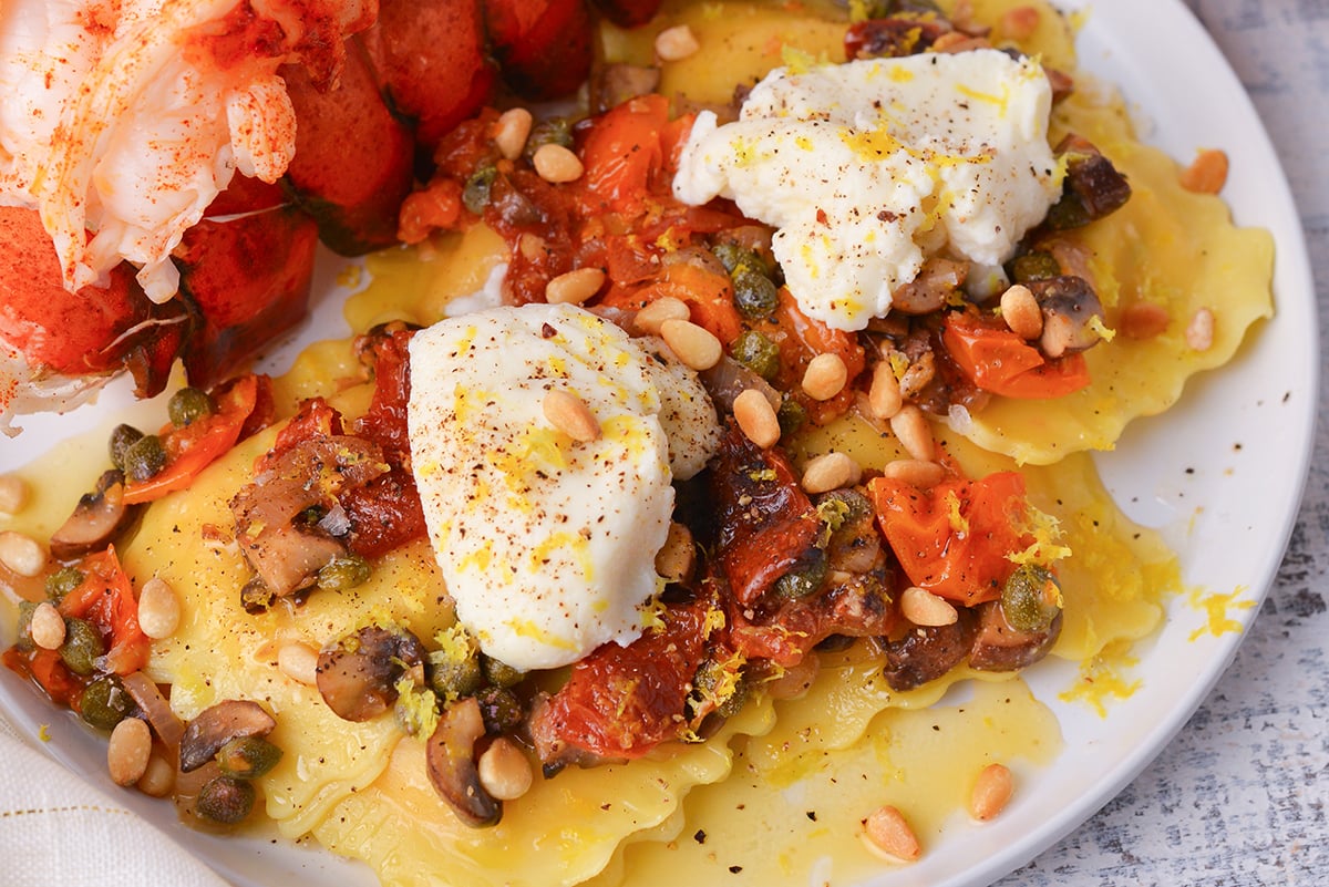 close up overhead shot of mediterranean lobster ravioli on a plate