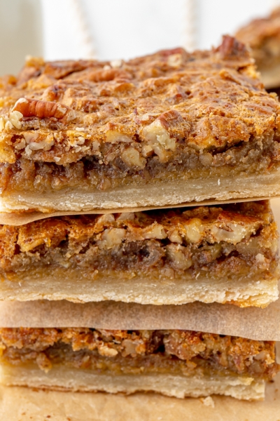 angled shot of stack of pecan pie bars