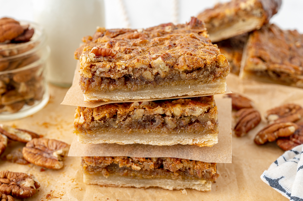 angled shot of stack of pecan pie bars