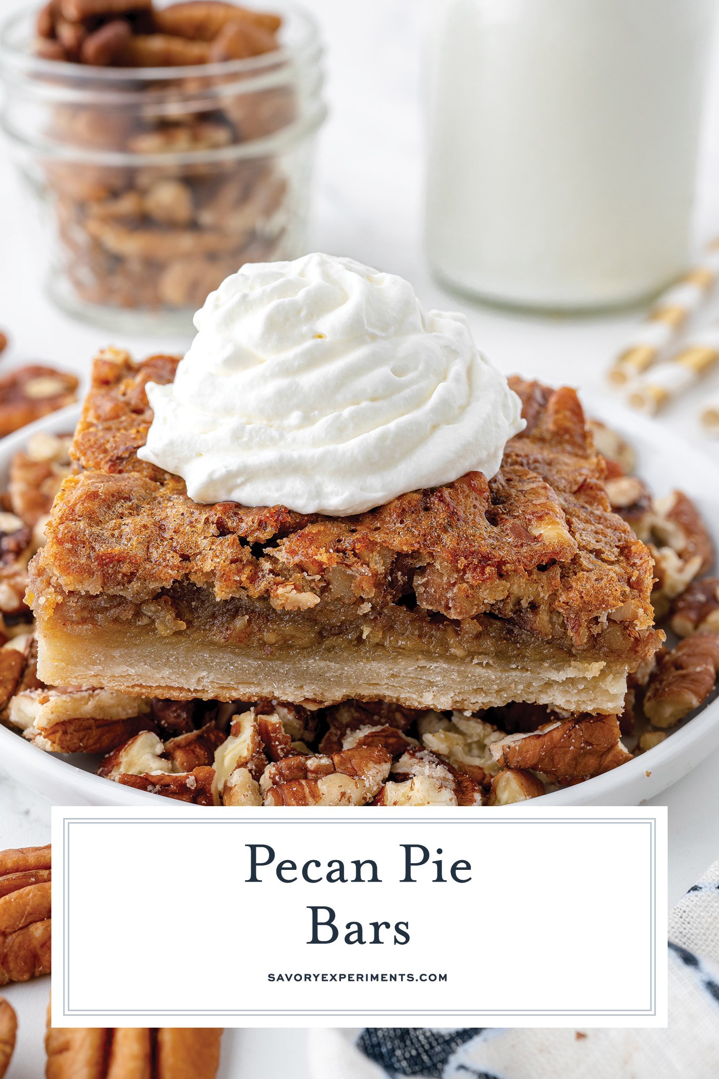 angled shot of pecan pie bar on plate topped with whipped cream with text overlay for pinterest