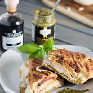 angled shot of pesto chicken panini on plate