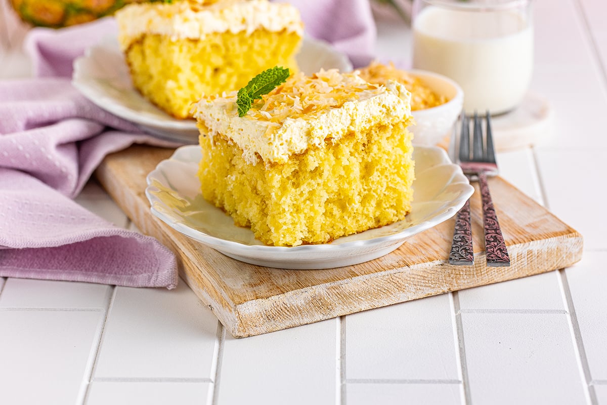 two slices of pina colada cake on serving plates