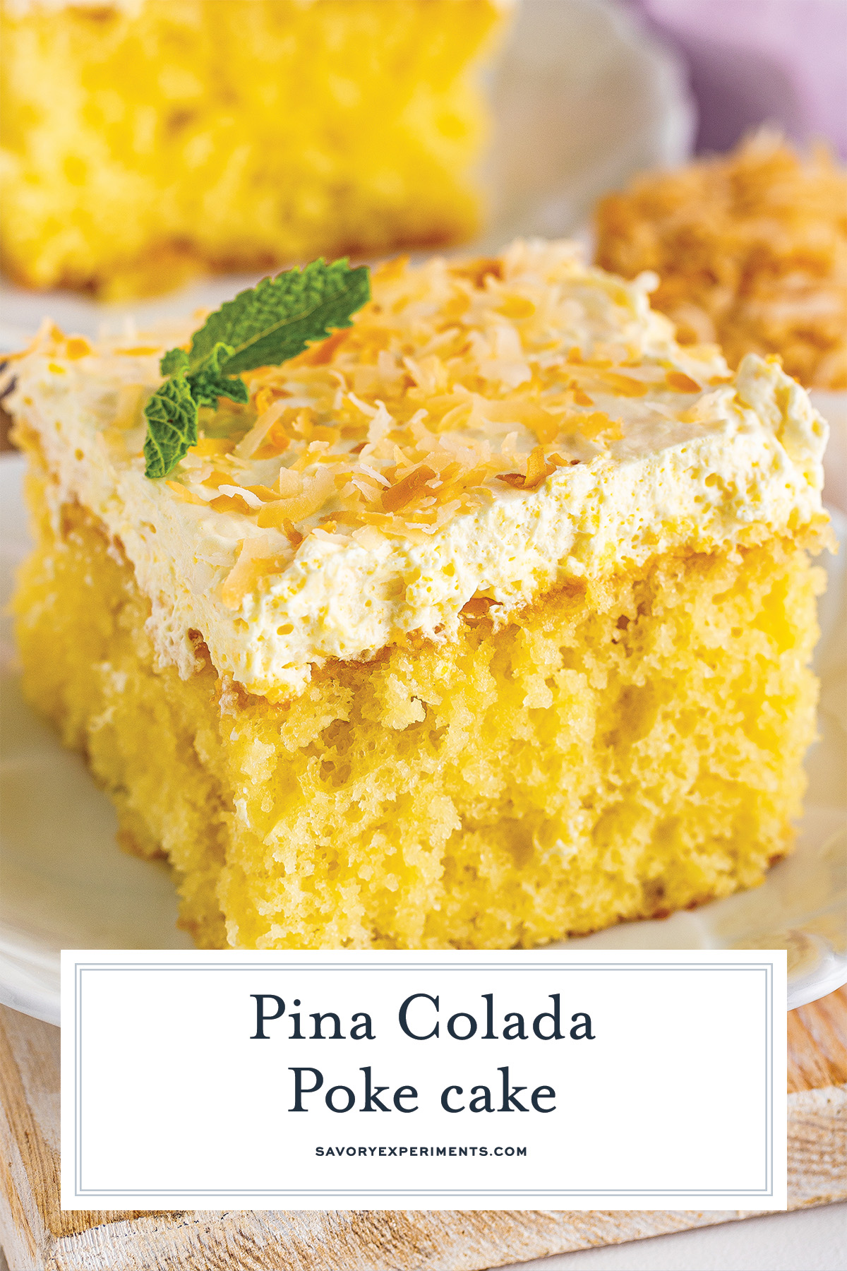 close up slice of pina colada cake with coconut flakes on top